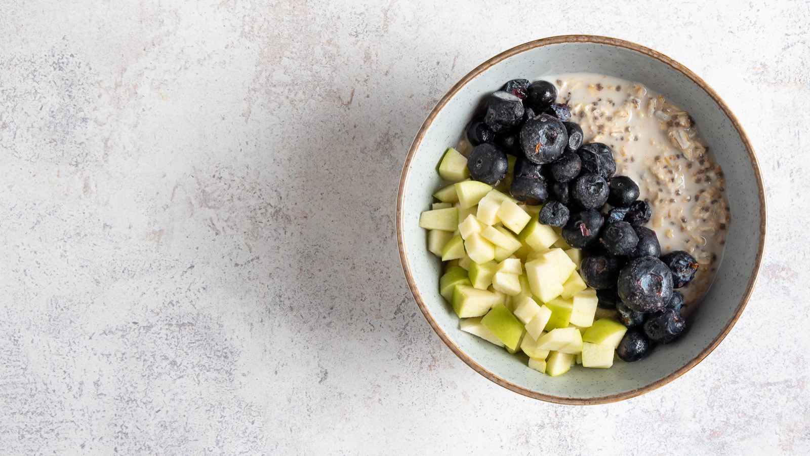 azón de avena con arándanos, kiwi y topping de frutos secos.